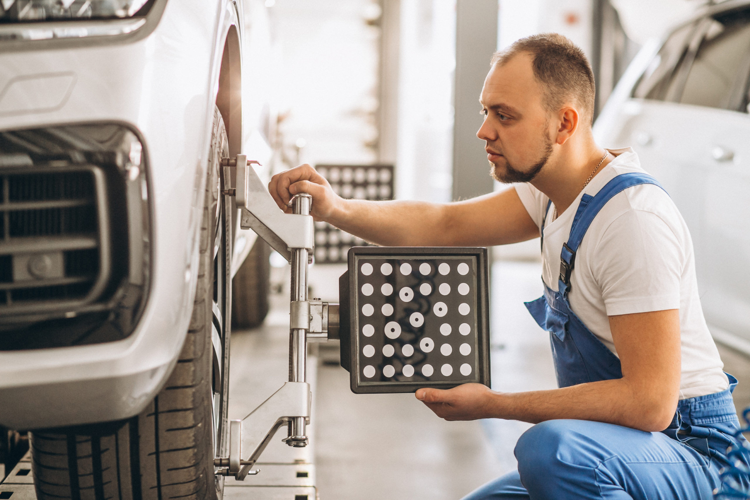 Auto mechanic checking car