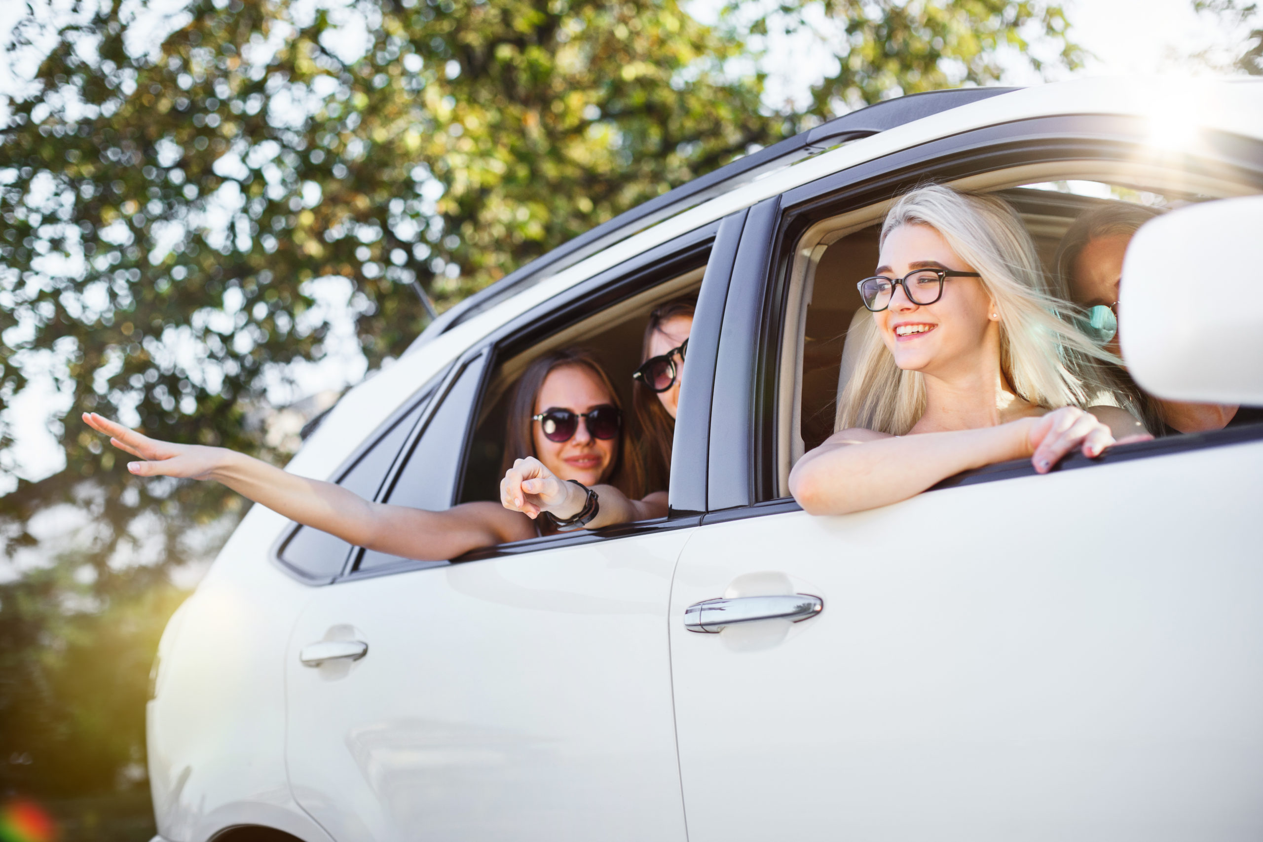 The young women in the car smiling