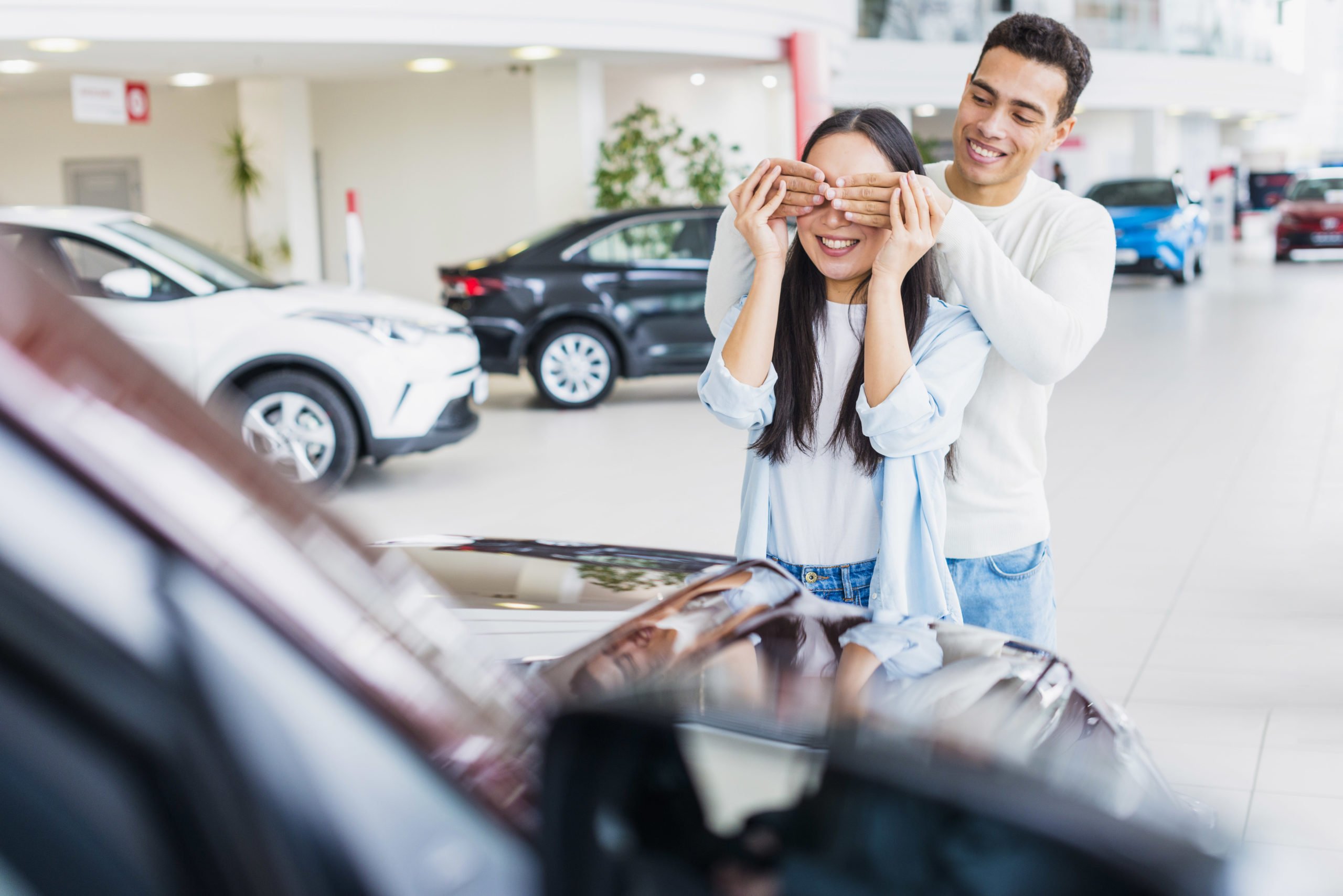 happy-couple-car-dealership